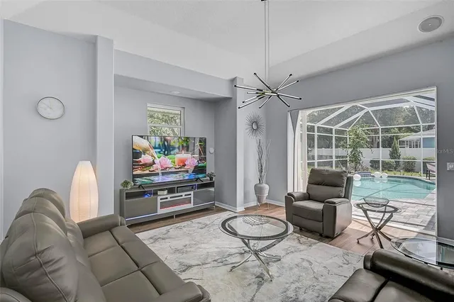 a living room with furniture a rug and a flat screen tv