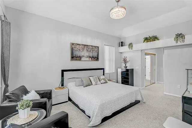 a bedroom with a bed and a chandelier