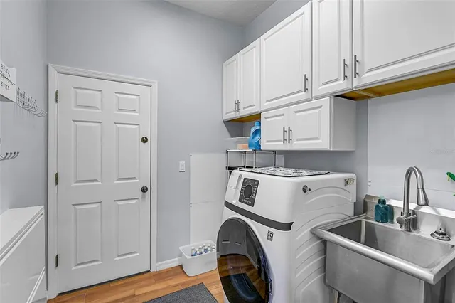a view of kitchen and utility room with wooden floor
