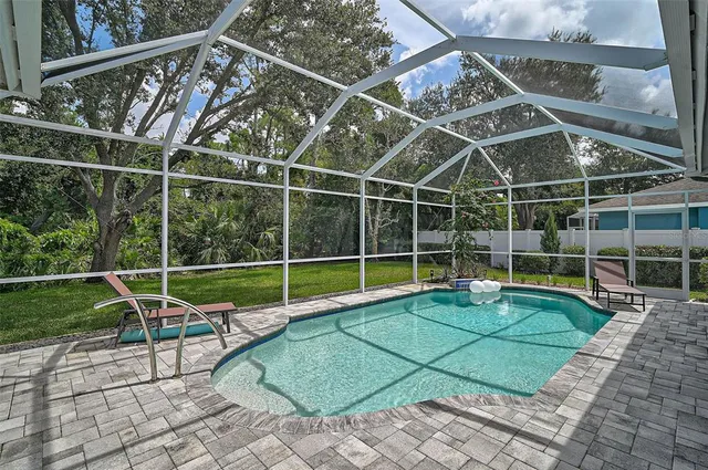 a view of a backyard with a wooden deck and a chair