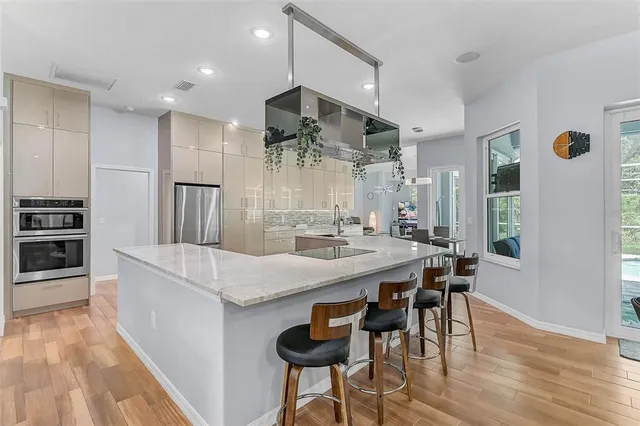 a large kitchen with a table and chairs