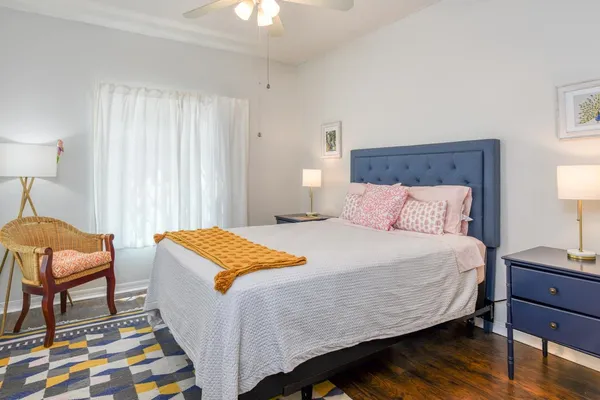 a bedroom with a bed and chair