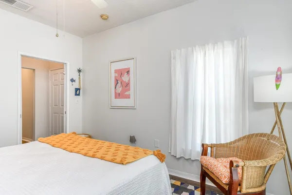 a bedroom with a bed and a chair