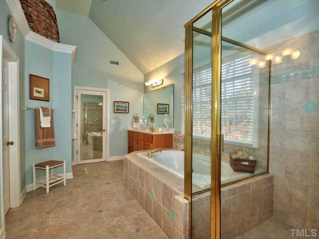 9437 Macon Road Raleigh, NC 27613 - Photo 15 of 25 Master bath features tile floor, garden tub, his/her sinks, ceiling fan, and large walk in closet. Master Bath/Spa