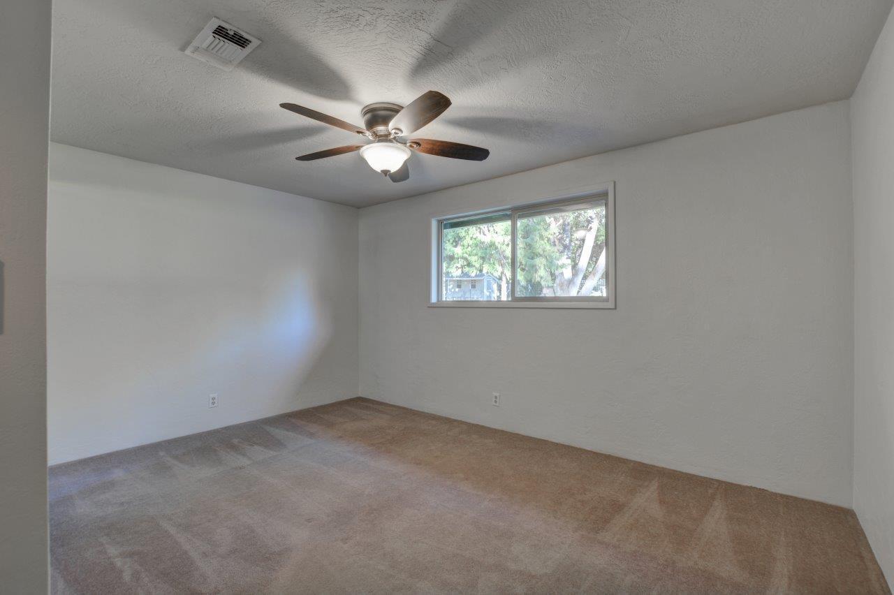 833 Upper Applegate Road Jacksonville, OR 97530 - Photo 26 of 58 an empty room with windows and fan
