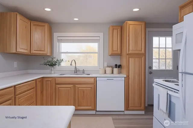 a kitchen that has a sink and a stove in it
