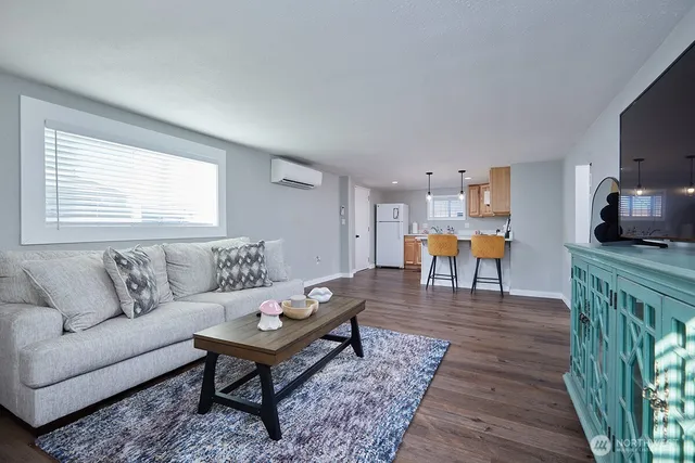 a living room with furniture a dining table and a flat screen tv