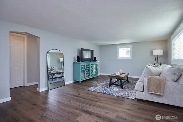 a living room with furniture and wooden floor