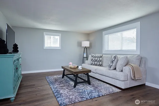 a living room with furniture and a rug