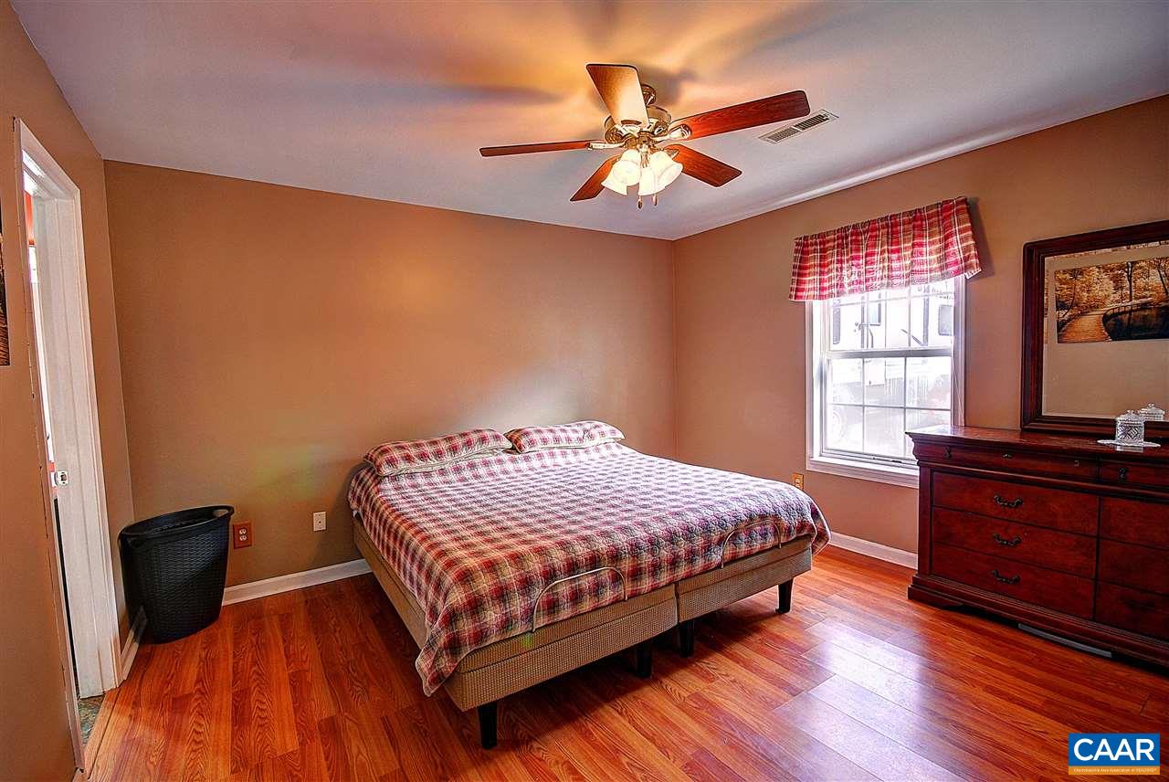 716 Jonquil Road Ruckersville, VA 22968 - Photo 11 of 21 a bedroom with a bed and wooden floor