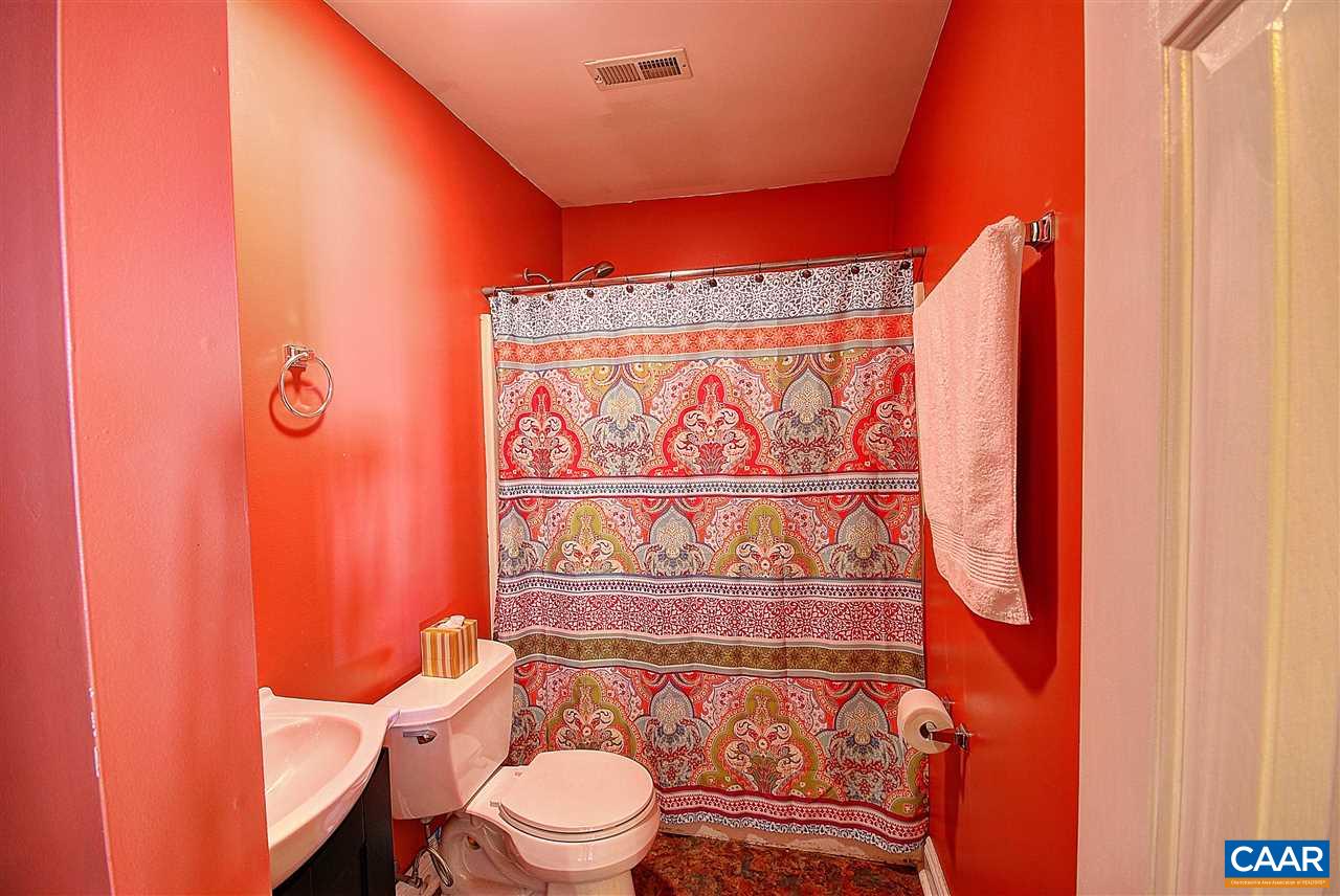 716 Jonquil Road Ruckersville, VA 22968 - Photo 16 of 21 a bathroom with a toilet and shower curtain