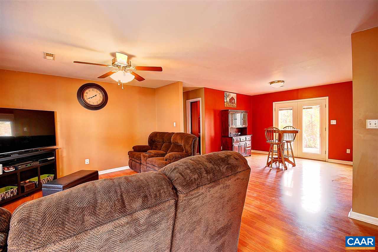 716 Jonquil Road Ruckersville, VA 22968 - Photo 3 of 21 a living room with furniture a flat screen tv and a large window