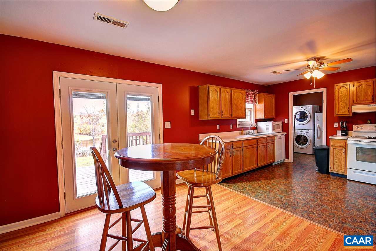 716 Jonquil Road Ruckersville, VA 22968 - Photo 4 of 21 a kitchen with a table chairs refrigerator and cabinets