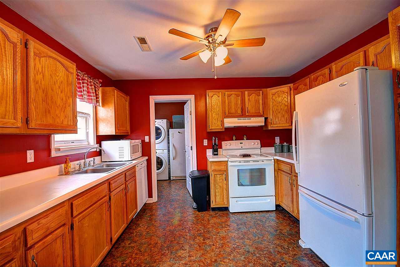 716 Jonquil Road Ruckersville, VA 22968 - Photo 6 of 21 a kitchen with stainless steel appliances granite countertop a refrigerator a sink dishwasher a stove with wooden floor and dining table