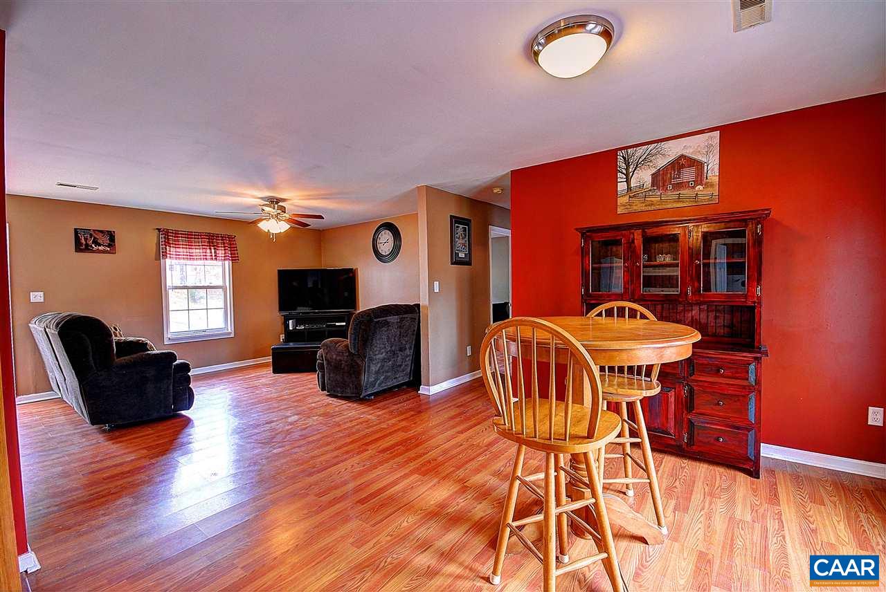 716 Jonquil Road Ruckersville, VA 22968 - Photo 9 of 21 a living room with furniture a flat screen tv and wooden floor