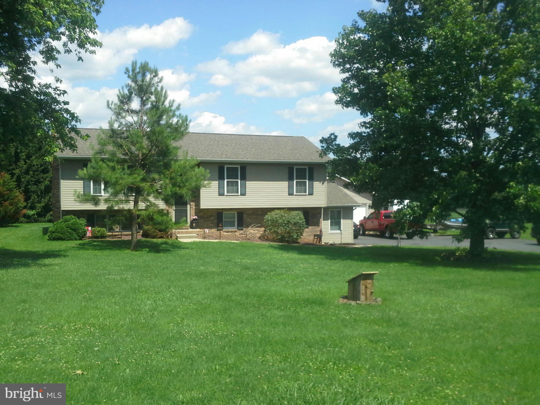 260 Connelly Road Rising Sun, MD 21911 - Photo 2 of 6 a front view of a house with a garden and trees