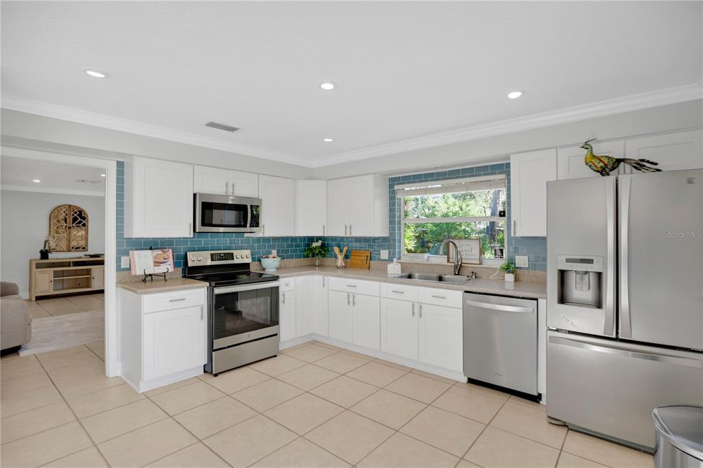 557 Karen Avenue Altamonte Springs, FL 32701 - Photo 11 of 35 a kitchen with white cabinets and white appliances