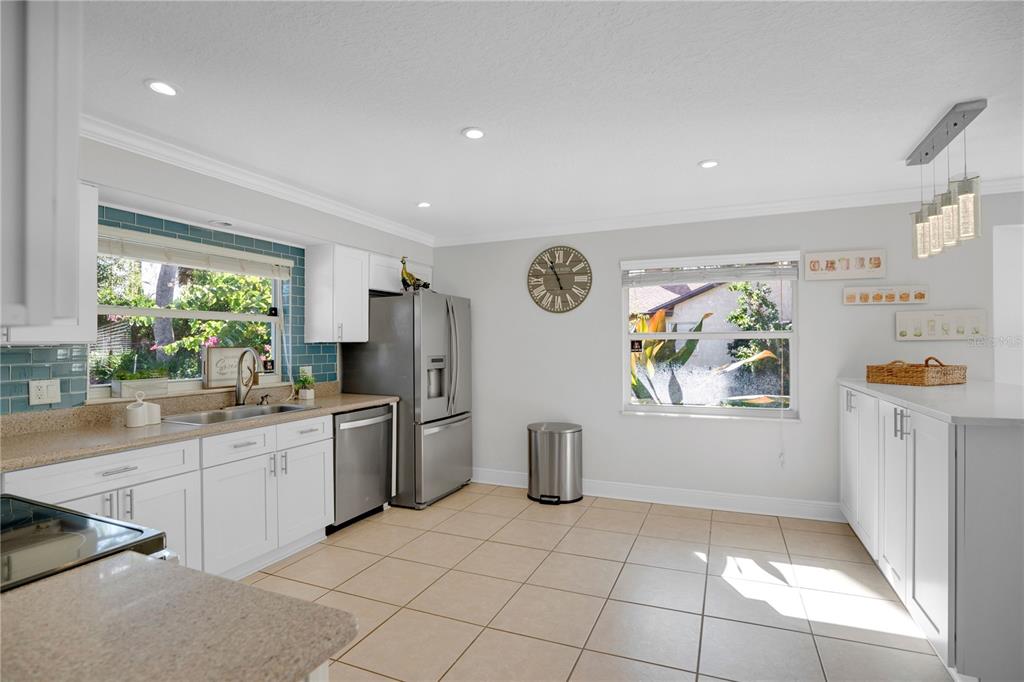 557 Karen Avenue Altamonte Springs, FL 32701 - Photo 12 of 35 a kitchen with stainless steel appliances a refrigerator and a stove top oven