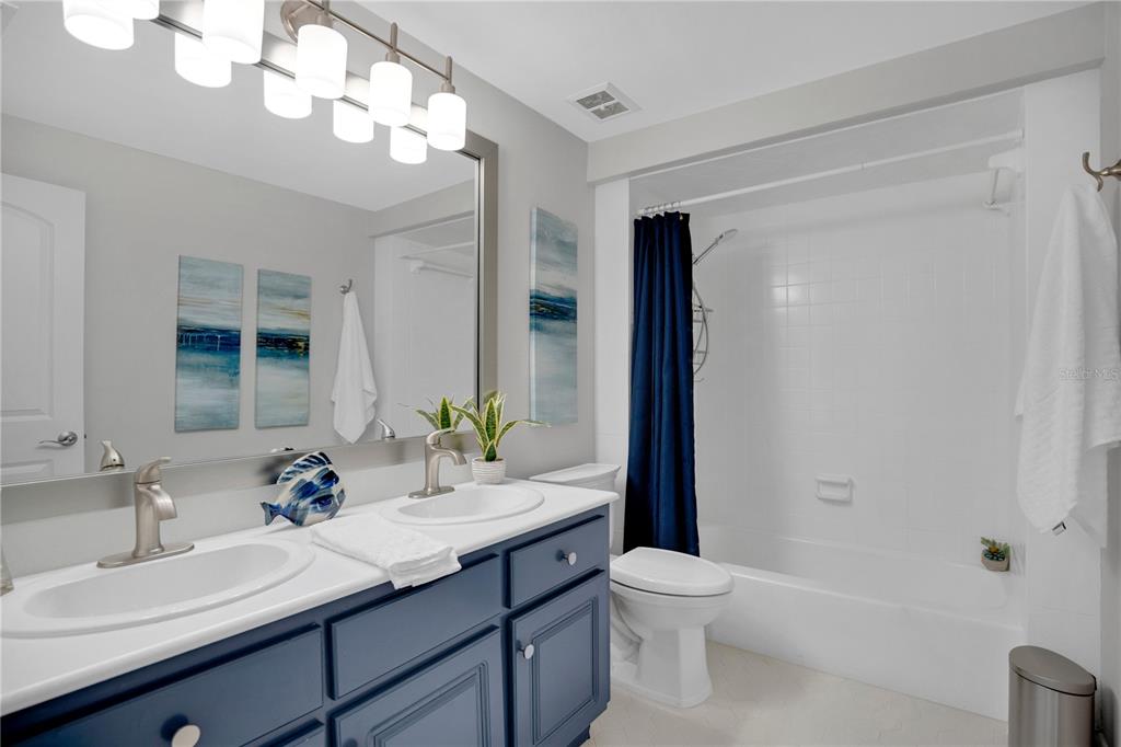 557 Karen Avenue Altamonte Springs, FL 32701 - Photo 17 of 35 a bathroom with a granite countertop sink a toilet and a mirror