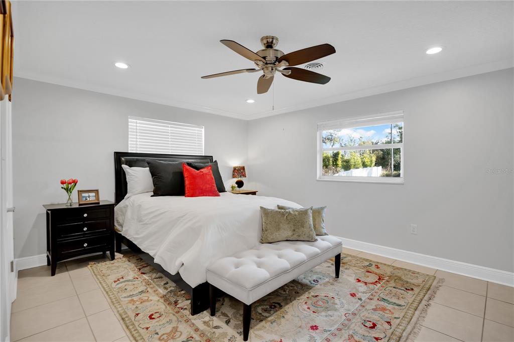 557 Karen Avenue Altamonte Springs, FL 32701 - Photo 19 of 35 a bedroom with a bed and a lamp on the dresser