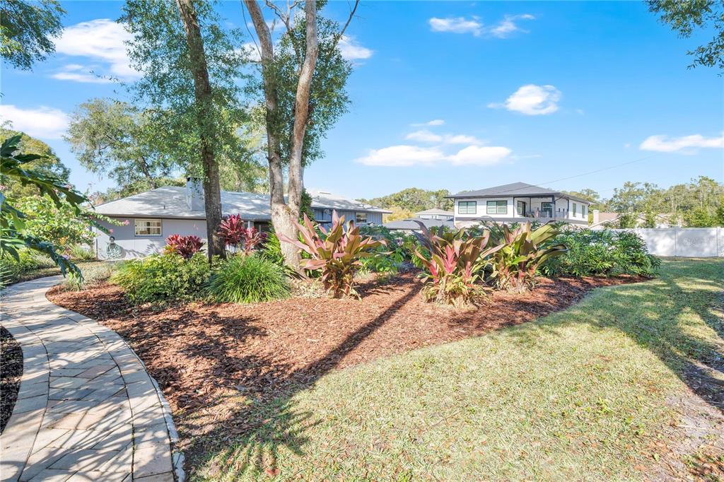 557 Karen Avenue Altamonte Springs, FL 32701 - Photo 27 of 35 a view of a garden with plants and a bench