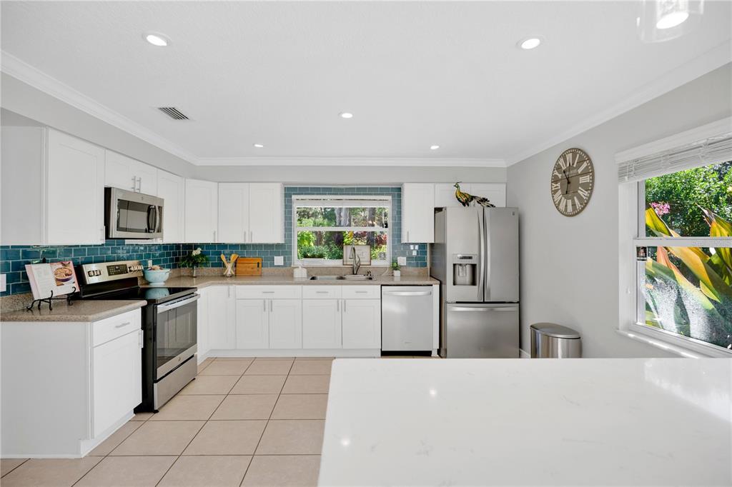 557 Karen Avenue Altamonte Springs, FL 32701 - Photo 7 of 35 a kitchen with refrigerator and cabinets