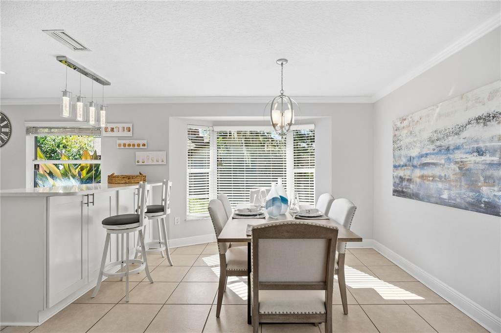 557 Karen Avenue Altamonte Springs, FL 32701 - Photo 8 of 35 a dining room with furniture a chandelier and wooden floor