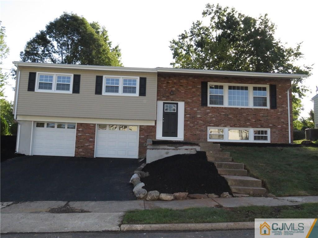 58 Harmon Road Edison, NJ 08837 - Photo 1 of 20 a front view of a house with garden
