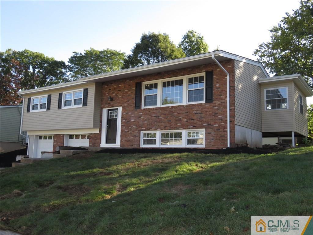 58 Harmon Road Edison, NJ 08837 - Photo 2 of 20 a view of a yard in front of a house with a large tree