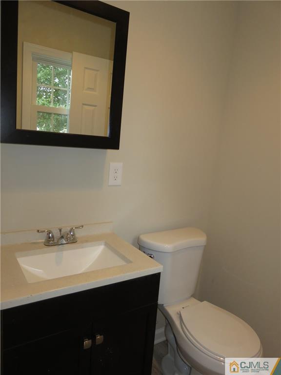 58 Harmon Road Edison, NJ 08837 - Photo 11 of 20 a bathroom with a sink mirror and toilet
