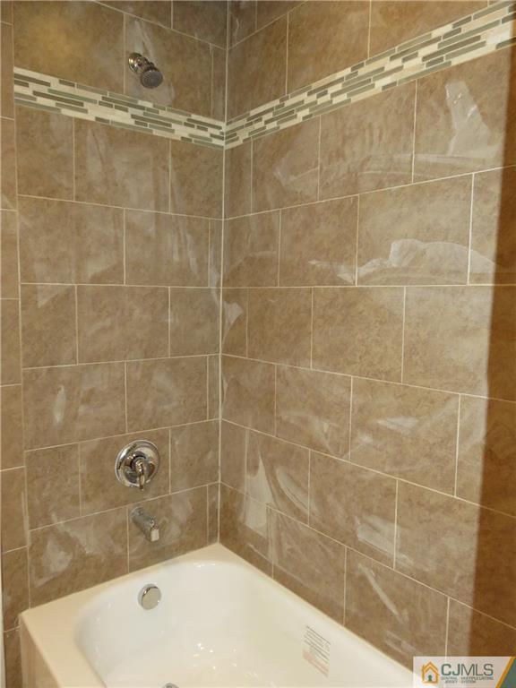 58 Harmon Road Edison, NJ 08837 - Photo 16 of 20 a bathroom with a bathtub