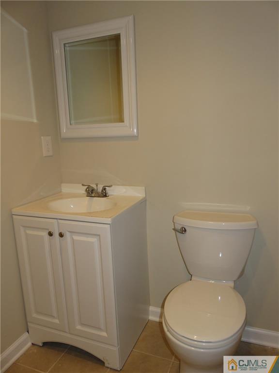 58 Harmon Road Edison, NJ 08837 - Photo 19 of 20 a white toilet sitting next to a bathroom sink