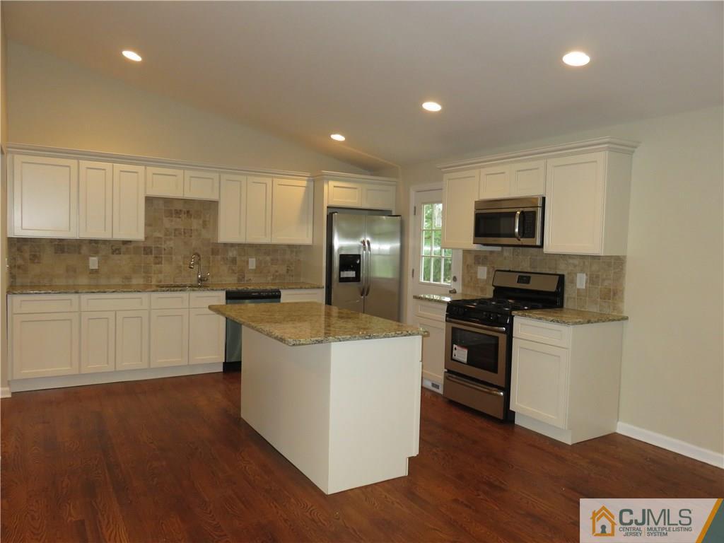 58 Harmon Road Edison, NJ 08837 - Photo 4 of 20 a kitchen with stainless steel appliances kitchen island granite countertop a stove a sink and a refrigerator