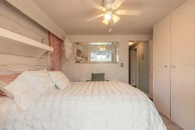 a bedroom with a large bed and a chandelier