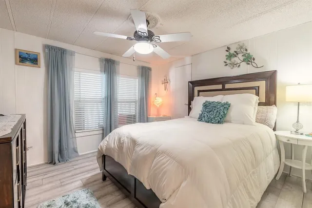a bedroom with a large bed and a chandelier
