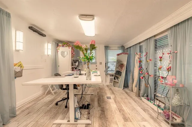 a view of a livingroom with furniture window and wooden floor