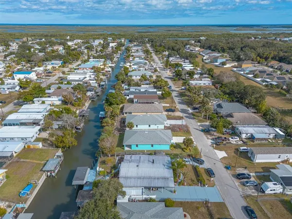 an aerial view of a house with a yard and lake view