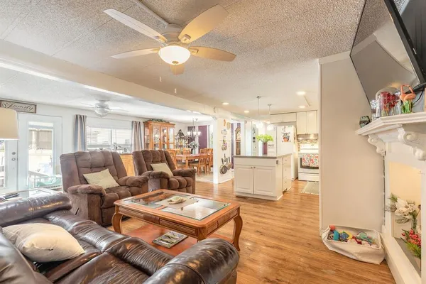 a living room with furniture and kitchen view