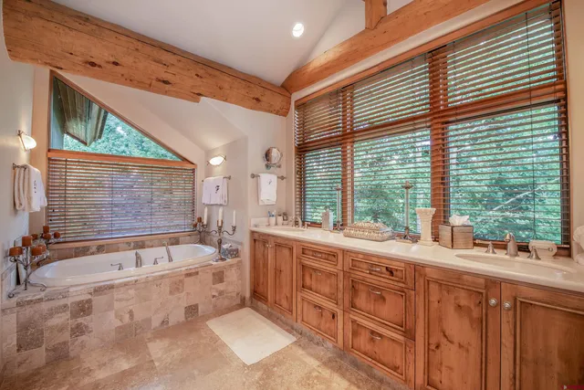 a spacious bathroom with a large tub and sink