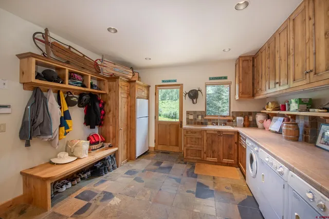 a kitchen that has a lot of cabinets in it and wooden floors