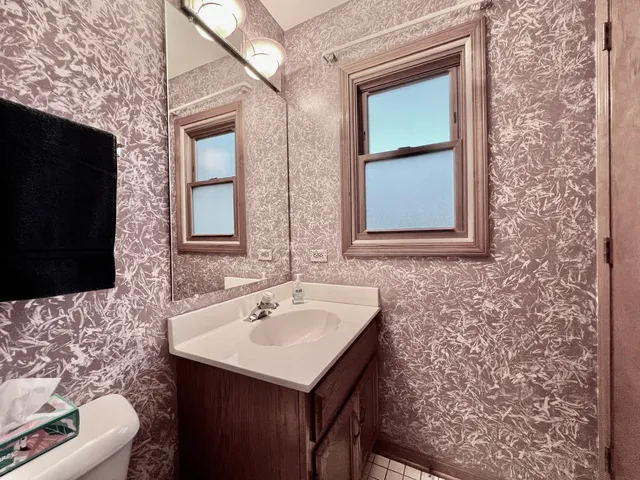 a bathroom with a sink a toilet and mirror