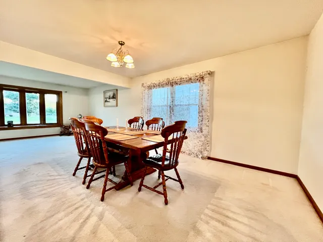 a view of a dining room with furniture and a chandelier