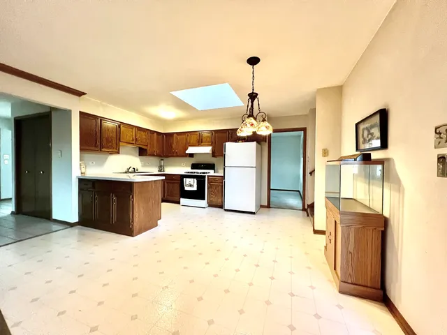 a view of kitchen and a refrigerator in a kitchen