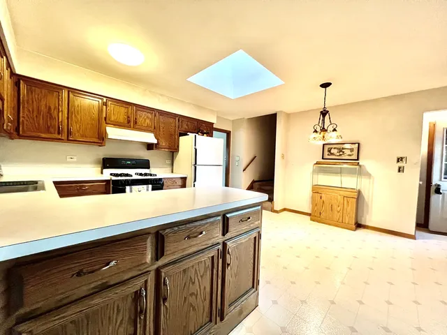 a kitchen with stainless steel appliances a sink a stove and a refrigerator