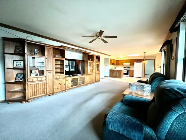 a living room with furniture and kitchen view