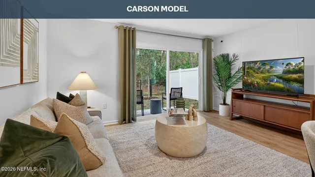 a living room with furniture and a flat screen tv