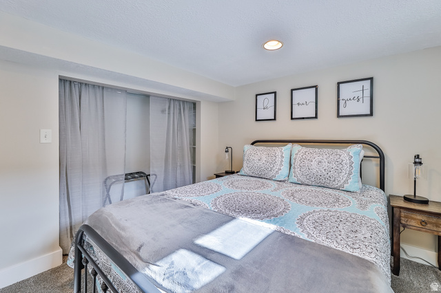 59 East 8680th Street South Sandy, UT 84070 - Photo 20 of 33 Bedroom featuring light neutral wall paint, recessed lighting, and carpet flooring