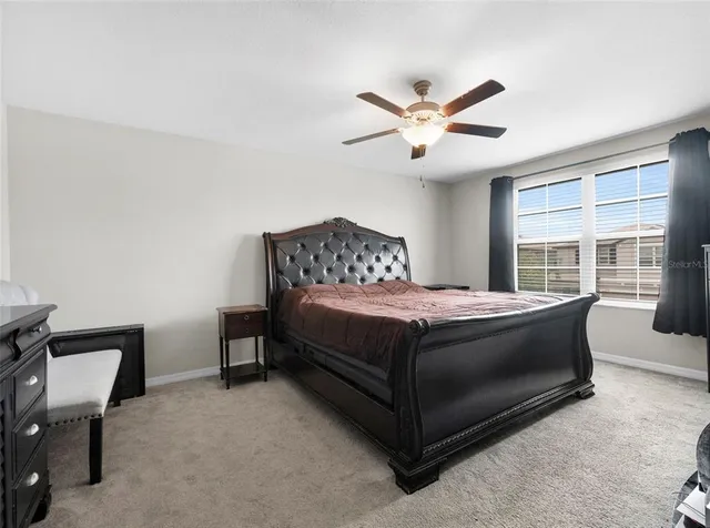 a bedroom with a bed and a large window