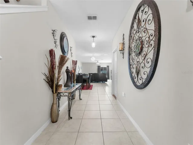 a view of a hallway with paintings on the wall