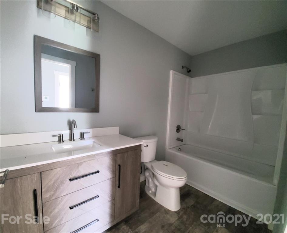 446 Porter Road Rock Hill, SC 29730 - Photo 9 of 15 a bathroom with a toilet a sink a mirror and a bathtub